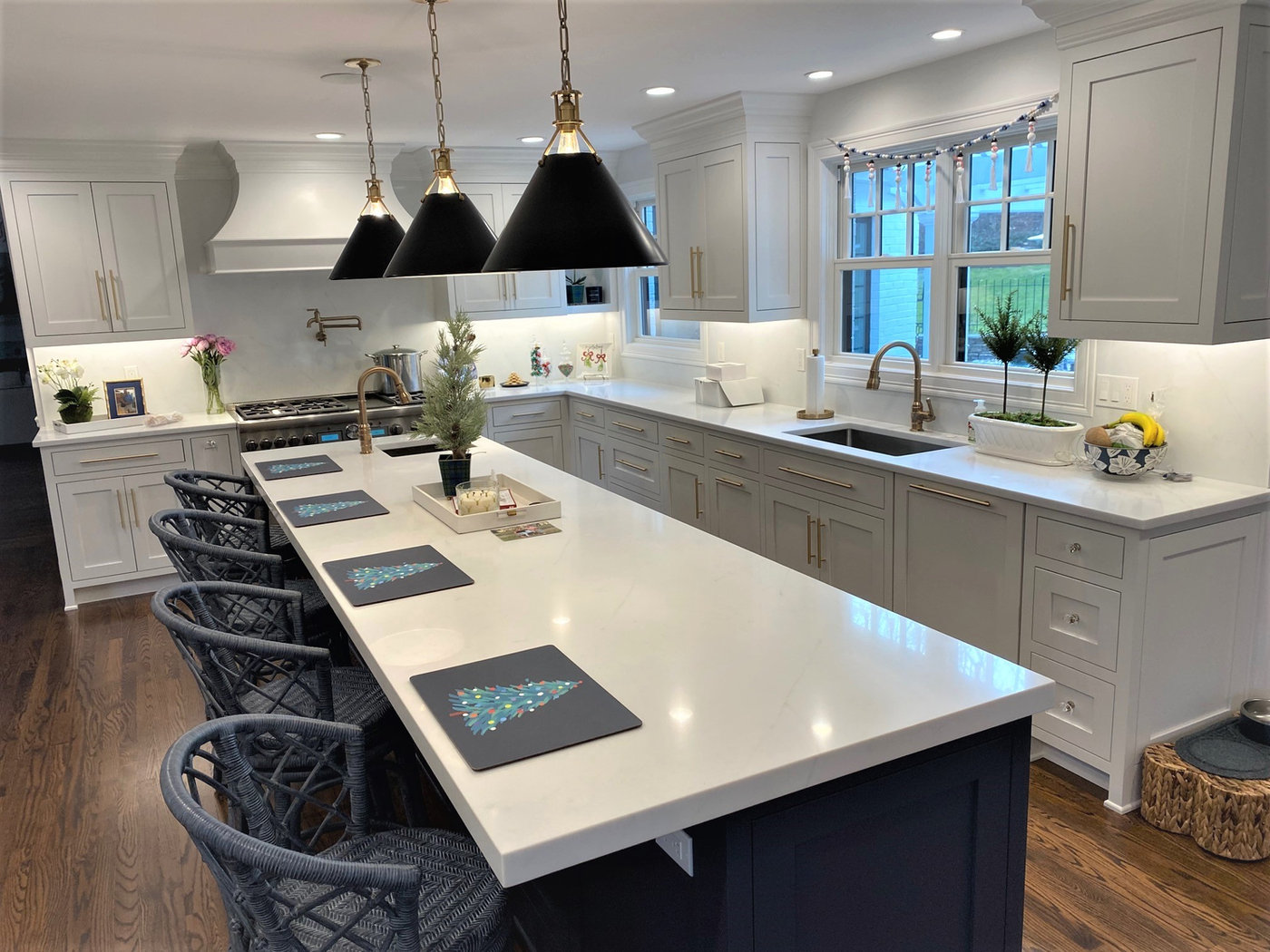 White quartz kitchen with an oversized island seating six, fabricated and installed by Pistritto Marble